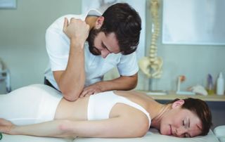 Massage d'une femme par un kinésithérapeute